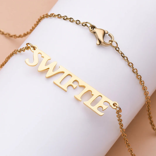 Celebrate your love for Taylor with this stylish 44cm gold-plated “Taylor” nameplate necklace, designed for true Swifties. Made from high-quality stainless steel, this elegant pendant shines with a polished finish and timeless design. Lightweight and durable, it’s perfect for daily wear or gifting to a girlfriend, best friend, or fellow fan. Whether you're heading to a concert or just want to carry a piece of your favorite artist with you, this necklace adds the perfect touch of fandom and fashion.